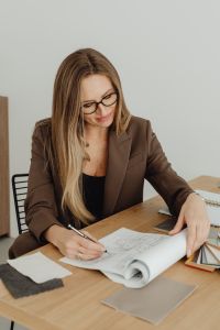 Kaboompics - Interior Designer Sketching Floor Plan With Material Samples