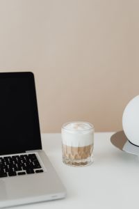 Kaboompics - Laptop and a glass of Cafe Latte on the desk