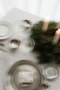 Kaboompics - Motion Blur Overhead Christmas Table with Lit Advent Wreath and Place Settings