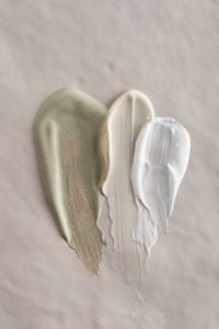 Kaboompics - Green, White and Beige Skincare Cream Swatches on a Neutral Surface, Macro Beauty Texture for Cosmetic Branding
