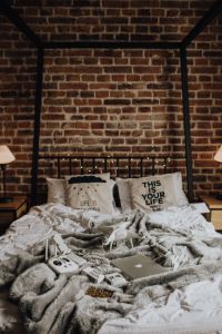 Drone, laptop and accessories lie on the bed ready for travel