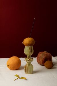 Kaboompics - Incense Stick Balanced on Citrus and Vintage Glass Candlestick