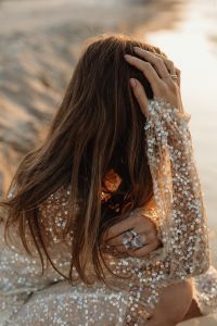 Kaboompics - Woman in Sequin Dress with Statement Rings at Golden Hour
