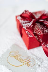 Kaboompics - Red Gift Box and Gold Thank You Card in a Snow-Dusted Holiday Flat Lay
