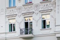 Kaboompics - White Ornamental Tenement Facade with Balcony on Piotrkowska Street, Łódź