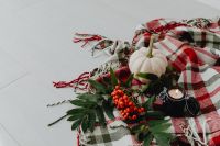Kaboompics - White Pumpkin, Black Candle and Rowan Berries on a Plaid Blanket