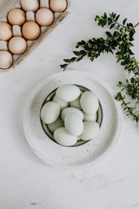 Kaboompics - Easter flat lay with green eggs on a white marble