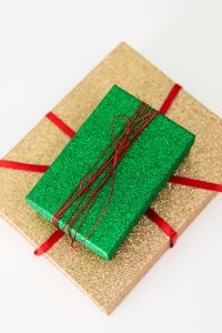 Kaboompics - Green Glitter Gift Box with Red Ribbon on Gold Present
