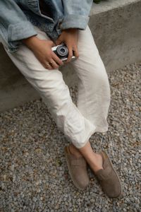 Kaboompics - Vintage Film Camera Resting On A Lap Outdoors