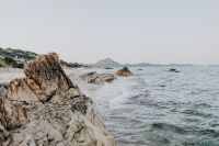 Kaboompics - Rocky Shore and Gentle Sea Waves under a Pale Sky, Minimal Coastal Background for Travel Design