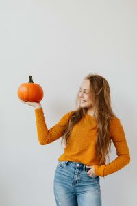 Kaboompics - Vertical Portrait of Woman Holding Pumpkin