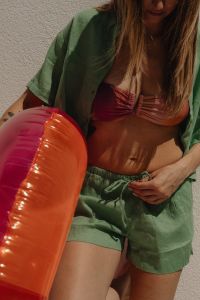 Kaboompics - Woman in Pink Bikini and Green Cover-Up Beside an Inflatable Ring