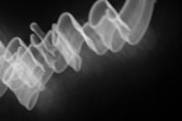Kaboompics - Swirling Red Neon Light Trails Against Black Background