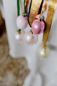 Kaboompics - Hanging Pink and White Easter Baubles on Gold and Green Ribbon, Close-Up