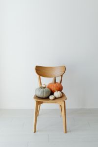 Kaboompics - Pumpkins on a Wooden Chair Against White Wall