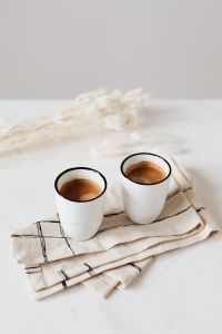 Kaboompics - Two Espresso Cups on a Checked Linen Napkin with Dried Wheat Stems