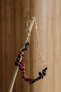Kaboompics - Red and Black Beaded Necklace Hanging from a Rod