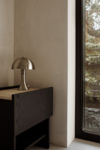 Kaboompics - Metallic Table Lamp on Black Sideboard beside Window, Interior Copy Space