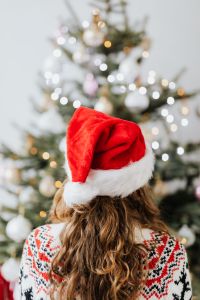 Kaboompics - Woman in Santa Hat, Christmas Tree Background