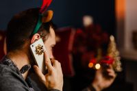 Kaboompics - Man Taking a Phone Call in a Warm Christmas Setting