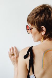Kaboompics - Woman's Back with Rainbow Body Paint and Botanical Tattoo