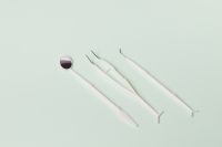 Kaboompics - Three Disposable Dental Tools on Mint Green Background