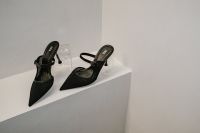 Kaboompics - Pair of Black Pointed Slingback Heels on White Ledge