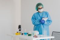 Kaboompics - Chemistry Teacher Recording Experiment Results in Notebook