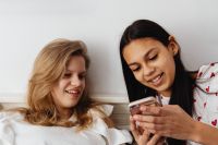 Kaboompics - Smiling Teen Friends Sharing a Laugh in a Cozy Home Portrait