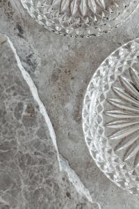 Kaboompics - Vertical Neutral Marble Background with White Stone Board and Crystal Dishes