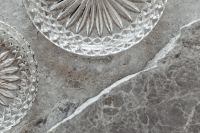 Kaboompics - Gray Marble Texture Background with Cut Crystal Dishes and White Veining