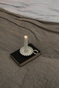Kaboompics - Lit Candle on Gray Bedding