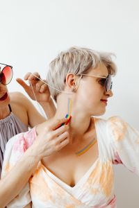 Kaboompics - Woman in Sunglasses Getting Rainbow Paint on Her Neck
