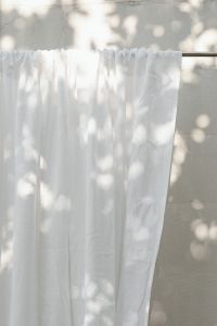 Kaboompics - White Curtain on Rail Against a Sunlit Wall