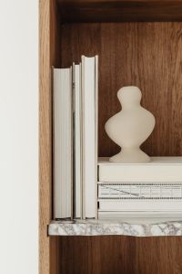 Kaboompics - Upright Books and Sculptural Ceramic Vase in a Walnut Bookcase