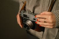 Kaboompics - Photographer Holding A Vintage Rangefinder Camera