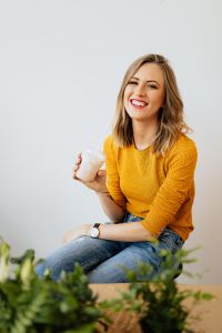 Kaboompics - Smiling Woman Posing with a Milkshake and Greenery