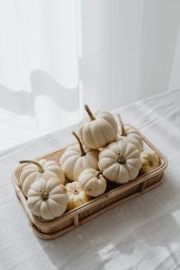 Kaboompics - White Mini Pumpkins in a Wicker Tray on White Fabric