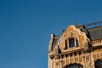 Kaboompics - Ornate Art Nouveau Tenement Roofline Against Blue Sky, Historic Architecture Detail