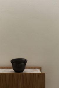 Kaboompics - Minimalist Neutral Interior with Black Ceramic Vessel on Wooden Console