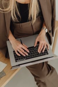 Overhead View of Hands Typing on Laptop