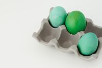 Kaboompics - Green and Turquoise Easter Eggs in a Gray Paper Carton