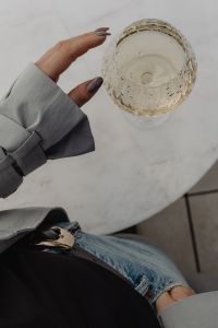 Kaboompics - Hand Reaching for Wine Glass at Marble Table