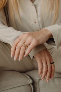 Kaboompics - Woman Wearing Gold Rings with Hands Resting on Lap