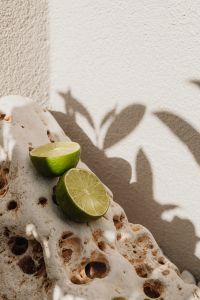 Kaboompics - Lime Still Life on Natural Stone with Sunlit Leaf Shadows