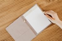 Kaboompics - Hand Writing in Lined Notebook With Gold Pen