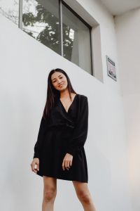 Kaboompics - Asian Woman in Black Dress against White Architecture with Minimalist Copy Space