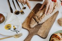 Kaboompics - Hands Preparing Bread on a Wooden Board