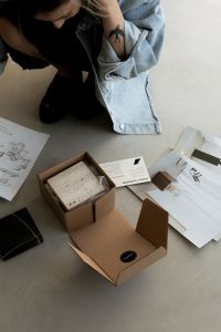Kaboompics - Interior Design Material Samples in Cardboard Boxes with Creative Studio Workspace