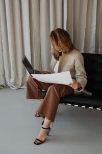 Kaboompics - Businesswoman Working on Her Laptop beside Office Curtains